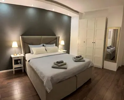 a bedroom with a large bed with two towels on it at Allure of Belgrade (80m2-861ft2) in Belgrade