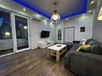 a living room with a couch and a tv at Allure of Belgrade (80m2-861ft2) in Belgrade