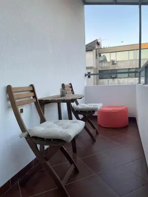 two chairs and a table on a balcony at Allure of Belgrade (80m2-861ft2) in Belgrade