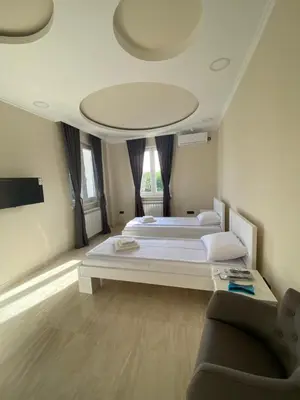 a large bedroom with a large bed and a couch at Vila Eleonora Beograd in Belgrade