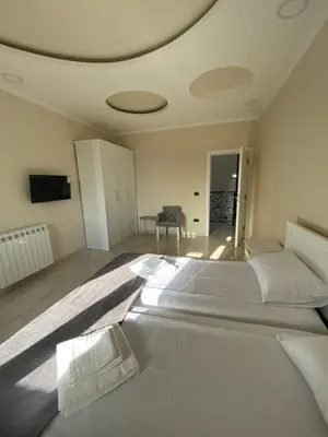 a bedroom with two large white beds in it at Vila Eleonora Beograd in Belgrade
