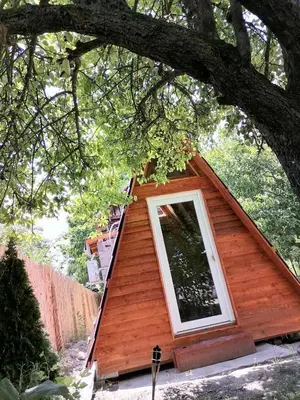 a small house with a window in a tree at VisitorsCenter Ivanovo in Ivanovo