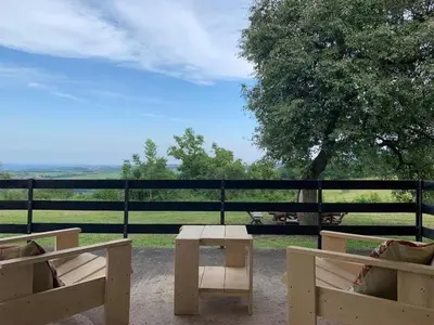 a table and two benches in front of a fence at Talin Raj in Arandjelovac