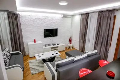 a living room with a couch and a tv at Silver in Žarkovo