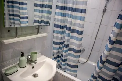 a bathroom with a sink and a shower at Silver in Žarkovo
