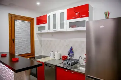 a kitchen with red cabinets and a stainless steel refrigerator at Silver in Žarkovo