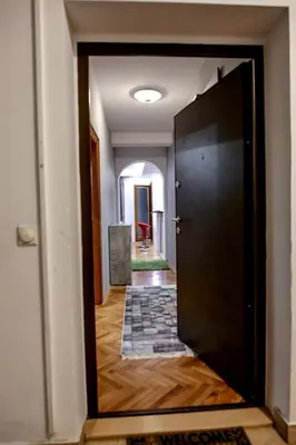a door leading into a room with a hallway at Silver in Žarkovo