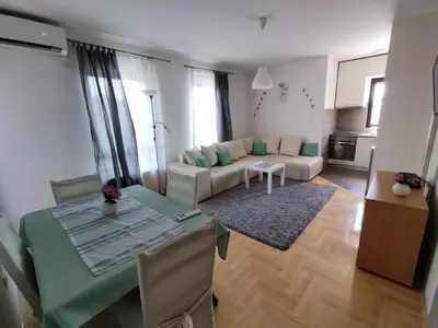 a living room with a table and a couch at Apartman GANA Altina , FREE PARKING in Novi Grad