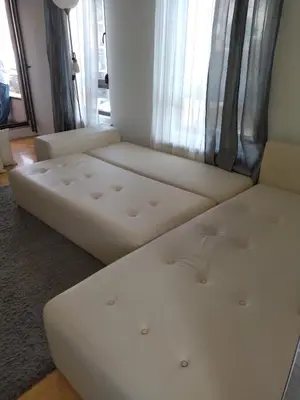 a living room with two white couches in front of a window at Apartman GANA Altina , FREE PARKING in Novi Grad