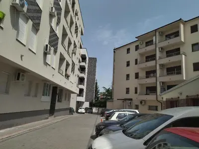 a street with cars parked next to tall buildings at Apartman GANA Altina , FREE PARKING in Novi Grad