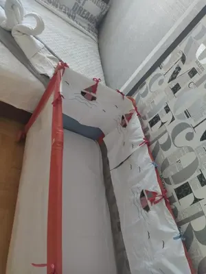 a bed with a red and white sheet on it at Apartman GANA Altina , FREE PARKING in Novi Grad