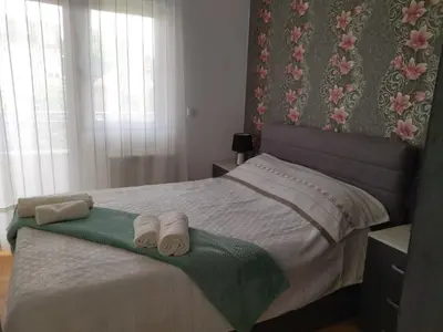 a bedroom with a bed with two towels on it at Apartman GANA Altina , FREE PARKING in Novi Grad