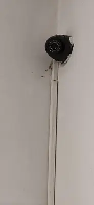 a wall with a light on the corner of a room at Sasa's Apart in Vračar (historical)