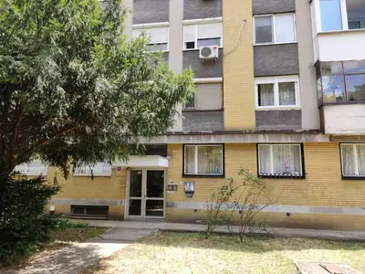 an apartment building with a yellow and gray at Sasa's Apart in Vračar (historical)
