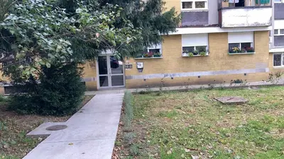 a sidewalk in front of a building with a door at Sasa's Apart in Vračar (historical)
