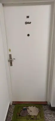 a white door with a sign on it in a room at Sasa's Apart in Vračar (historical)