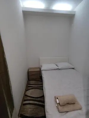 a small bedroom with a bed with a bag on it at Obilic 22 Apartment in Belgrade
