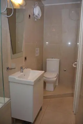 a bathroom with a white sink and a toilet at Obilic 22 Apartment in Belgrade