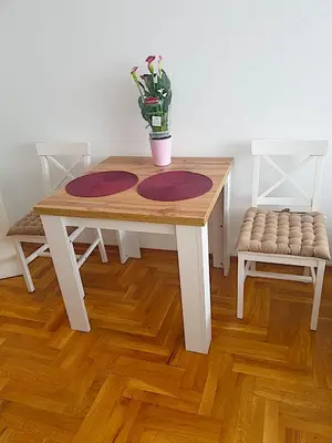 a wooden table with a potted plant on top of it at Belgradian 011 in Belgrade