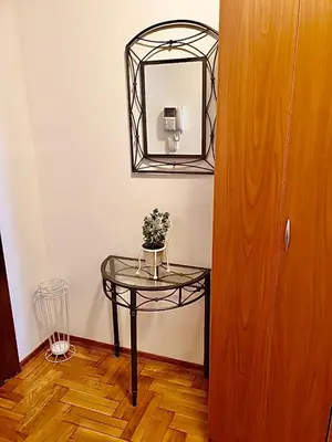 a glass table with a mirror on a wall at Belgradian 011 in Belgrade