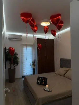 a room with red hearts hanging from the ceiling at ADA MOMENT Splav- kuca na reci Beograd- Floating House on SAVA RIVER ,Belgrade in Belgrade