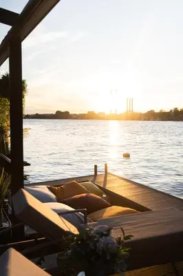 a group of pillows sitting on a dock on the water at ADA MOMENT Splav- kuca na reci Beograd- Floating House on SAVA RIVER ,Belgrade in Belgrade
