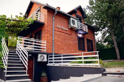a building with stairs and a sign on it at Villa Dijana - Pool, Spa, Outdoor Kitchen in Belgrade
