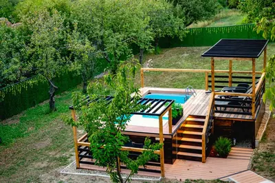 an outdoor deck with a pool and a gazebo at Villa Dijana - Pool, Spa, Outdoor Kitchen in Belgrade