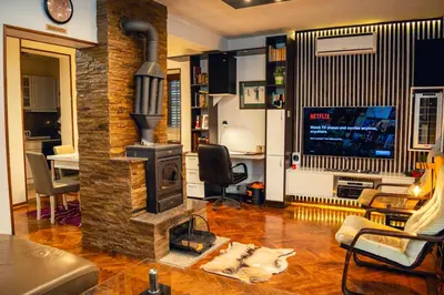 a living room with a wood stove in a room at Villa Dijana - Pool, Spa, Outdoor Kitchen in Belgrade
