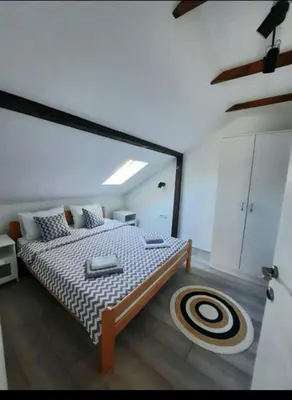 a bedroom with a large bed in a room at Galerija Park 1 in Arandjelovac
