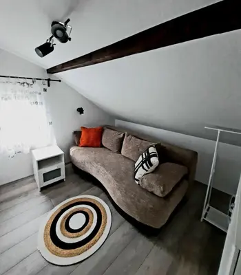 a living room with a couch and a table at Galerija Park 1 in Arandjelovac