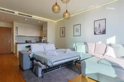a living room with a couch and a table at Belgrade Waterfront Luxury Appartment Pool & Gym in Belgrade