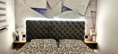 a bedroom with a bed with a black head board at MOON LUX Apartman Beograd in Belgrade