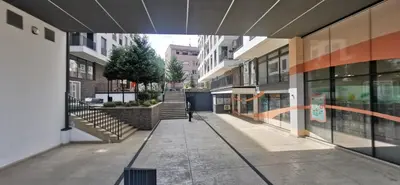 an empty sidewalk in a city with buildings at MOON LUX Apartman Beograd in Belgrade