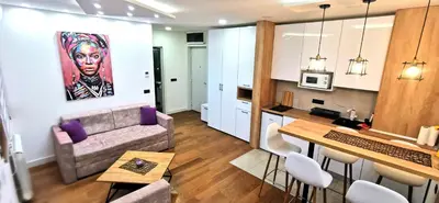 a living room with a couch and a table at MOON LUX Apartman Beograd in Belgrade