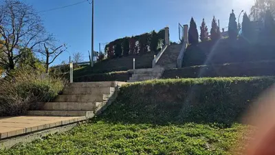 a set of concrete stairs with grass and trees at Vila POGLED in Arandjelovac