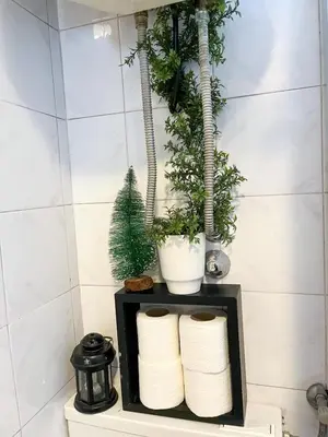 a shelf with towels and plants on it in a bathroom at Kopernik - parking available in Belgrade