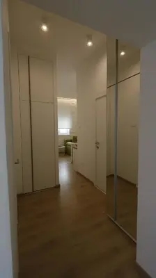 an empty room with a hallway with a glass door at Apartment Ana, Vračar, Belgrade in Belgrade