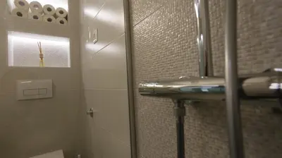 a bathroom with a shower with a sink and a mirror at Apartment Ana, Vračar, Belgrade in Belgrade