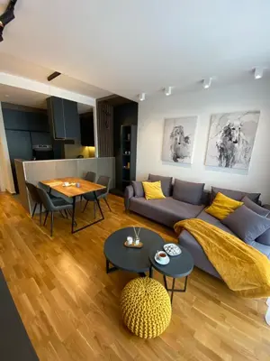 a living room with a couch and a table at DOM Boutique Apartments PARK VIEW in Belgrade