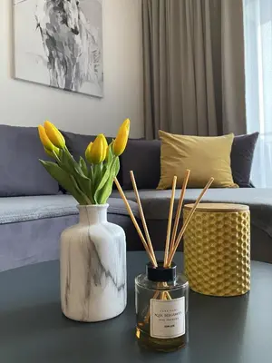 two vases with flowers on a table in a living room at DOM Boutique Apartments PARK VIEW in Belgrade