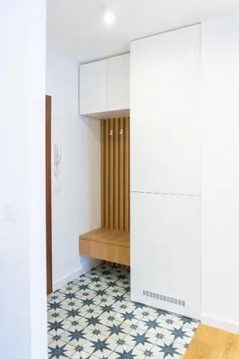 a room with a hallway with white walls and a tile floor at Akiton Apartment in Belgrade