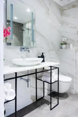 a white bathroom with a sink and a toilet at Akiton Apartment in Belgrade