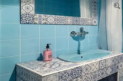a bathroom with a sink and a mirror at Wine house apartment in Karaburma