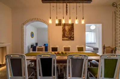 a dining room with a table and chairs at Wine house apartment in Karaburma
