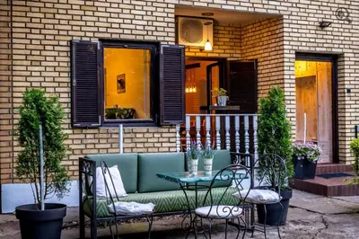 a patio with a couch and a table and chairs at Wine house apartment in Karaburma