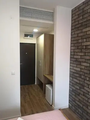 a room with a brick wall and a hallway at Apartman 25 in Belgrade