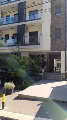 a building with a car parked in front of it at Apartman 25 in Belgrade