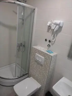 a bathroom with a shower with a toilet and a sink at Apartman 25 in Belgrade