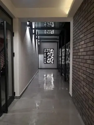 an empty hallway with a brick wall and a window at Apartman 25 in Belgrade